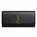 Saint Laurent Cassandre flat clutch in smooth black calfskin leather with oversized gold-tone YSL monogram on flap